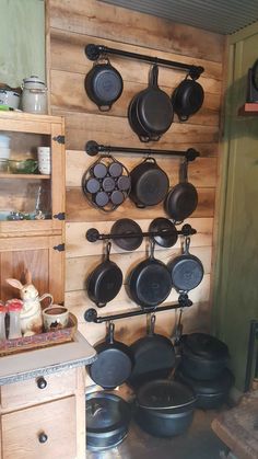 pots and pans are hanging on the wall