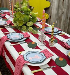 the table is set with plates and place settings