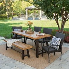 an outdoor dining table and bench set on a patio