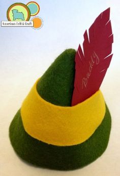 a green and yellow hat with a red feather