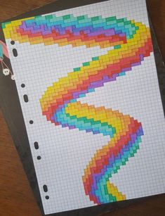 a piece of paper that has been made with colored squares on it and scissors next to it