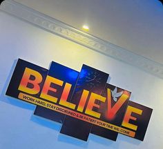 there is a sign that says believe on the wall