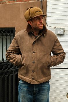 The N1 deck jacket was developed in late 1943, built on the experience and lessons learned of the early war years. Made from a hard-wearing 10 oz. heavyweight waxed canvas outer with a 6 oz. quilted liner, shearling collar and camo accents. The jacket featured a drawstring skirt, storm cuffs and a hidden chinstrap collar. It was hip-length and the warmth of the shearling collar gave the jacket its iconic profile. We love the original jacket but it needed a few changes to work in our everyday lif N1 Jacket, N1 Deck Jacket, Deck Jacket, Waxed Jacket, Drawstring Skirt, Vintage Mens Fashion, Wax Jackets, Winter Outfits Men, Flight Jacket