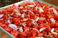 a pan filled with chopped tomatoes and onions