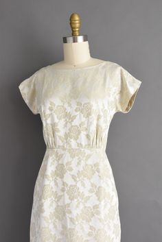 "Vintage 1950s dress in a wonderful ivory color with a lovely floral print throughout. This vintage dress features a flattering fitted bodice with bust darts, nipped waist, and a wonderful pencil skirt. There is a back metal zipper for closure. ✂------ M E A S U R E M E N T S ------- Best Fit: XS Bust: 32\" Waist: 24\" Hips: 34.5\" Shoulders: undefined Sleeves: 2\" Total Length: 36\" Material: silk brocade Condition: Excellent vintage condition. Ready to wear. ☆ Layaway is available for this ite 1950s Style Fitted Cream Vintage Dress, Cream 1950s Style Vintage Dress, Fitted Cream Dress In 1950s Style, Cream Fitted 1950s Style Dress, Cream Fitted Dress In 1950s Style, Fitted Cream Vintage Dress With Floral Print, 1950s Style Cream Vintage Dress, 1950s Style Cream Dress, Fitted Beige Vintage Dress For Garden Party