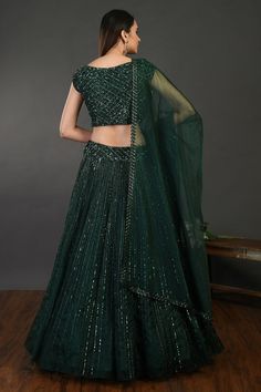 Beautiful bottle green embroidered designer lehenga with dupatta is perfect pick for festive and wedding occasions! Shop online from Pure Elegance. Disclaimer: The actual product may vary slightly from the image. These are custom orders, hence expect slight variation in color, placement of the motif or buta. ESTIMATED DELIVERYBecause this is a custom order, it would take about 4 weeks from the date of purchase. RETURN POLICYThis product is a custom order and cannot be returned or exchanged. Indian Designer Dresses, Lehenga With Dupatta, Sharara Suits, Wedding Lehengas, Suits Wedding, Lehenga Online, Fashion Journals, Designer Lehenga, Traditional Fabric