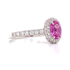 an oval shaped pink sapphire and diamond ring