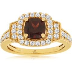 a yellow gold ring with a red stone surrounded by white diamonds