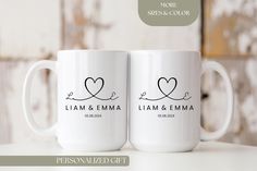 two white coffee mugs sitting on top of a table with the words personalized gifts