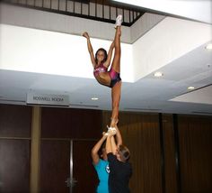 two people doing aerial acrobatics in an office building