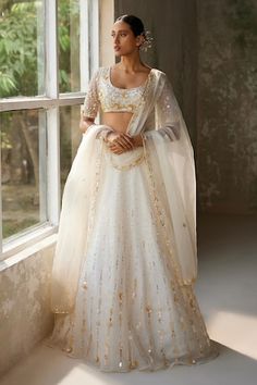 Ivory skirt with aari, sequin, thread embroidery in floral pattern. Paired with embroidered padded blouse and dupatta. - Aza Fashions Elegant White Choli With Floral Embroidery, White Organza Lehenga With Sequins, White Embellished Embroidered Saree Fabric, White Hand Embellished Semi-stitched Lehenga, White Sequined Organza Lehenga, Embroidered Semi-stitched Lace Lehenga, Festive White Embroidered Fabric With Sequins, White Embellished Saree Fabric, White Embellished Semi-stitched Lehenga