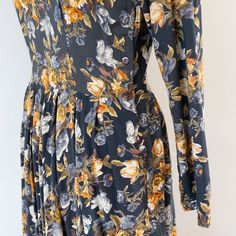 "A perfectly '90s floral rayon dress that would have been paired with chunky lug-soled boots (and probably should be styled that way again). ERA: early 1990s LABEL: Passports of Pier 1 Imports MATERIAL: 100% rayon TAG SIZE: L FITS LIKE: L MEASUREMENTS: Length: 51\" Bust: 38\" Waist: 32\" Hips: free (64\") (Note: measured lying flat and doubled, where necessary) DETAILS: Scoop neckline with long sleeve; lightly padded shoulders; fitted bodice with darts for flattering shape; pleated skirt; left s Fall Floral Print Midi Length Dress, Fitted Floral Print Midi Dress For Winter, Fitted Floral Print Dress For Fall, Fitted Ditsy Floral Dress For Fall, Fitted Floral Print Midi Dress For Fall, Vintage Floral Print Winter Dress, Long Sleeve Dresses With Vintage Print For Fall, Vintage Long Sleeve Floral Dress, Lug Sole Boots