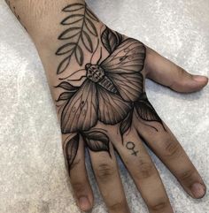 a person's hand with a tattoo on it