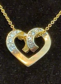 A dainty 14K solid yellow gold heart embraces six sparkly diamonds on a 14K yellow gold chain. The heart measures about 1 3/4 inches across and 5/8 of an inch long. The chain is 20" and stamped 14K and Italy. I do not enhance my photos, but I have to say, the photo does not do justice to the sparkliness of the diamonds.   A certified gemologist rated the diamonds H to I in color (near-colorless) and S12 in clarity (slight inclusions), and established the value of the piece. The heart is stamped 14K. What a romantic gift, either to a very dear friend--or to yourself, because you deserve it! Yellow Gold Diamond Necklace With Open Heart Design, Gold Heart-shaped Brilliant Cut Diamond Necklace, Yellow Gold Diamond Necklace With Open Heart Shape, Gold Heart Necklace With Diamond Accents, Gold Double Heart Diamond Necklace, Gold Diamond Necklace With Open Heart Charm, Formal Heart-shaped Yellow Gold Diamond Necklace, Gold Heart Pendant Necklace With Brilliant Cut, Gold Double Heart Diamond Cut Necklace