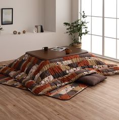 a living room with wood flooring and large window looking out onto the outside area