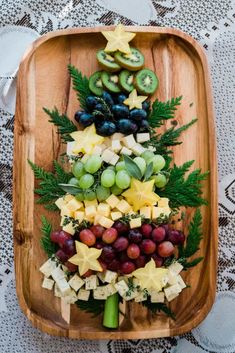 a wooden platter filled with fruit and vegetables