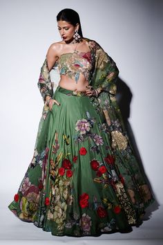 Green blossom print lehenga with floral corsage appliques and sequin embellishments. Comes with matching embellished cut-out blouse and dupatta.
Components: 3
Pattern: Embroidered,Printed
Type Of Work: Sequin, Floral Applique
Neckline: Halter
Sleeve Type: Sleeveless
Fabric: Organza
Color: Green
Other Details: 
Length:
Lehenga: 45 inches
Blouse: 14 inches
Note: Jewellery worn by the model is not for sale
Occasion: Cocktail,Reception - Aza Fashions Varun Bahl, Floral Corsage, Print Lehenga, Blossom Print, Dress Indian, Cocktail Reception, Dress Indian Style, Indian Designer, Indian Style