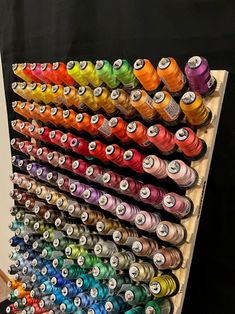 a rack with many spools of thread on it