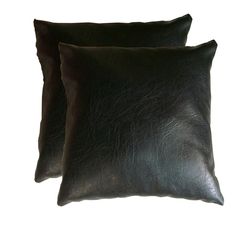 two black leather pillows sitting next to each other