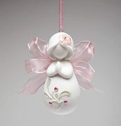 a white ornament hanging from a pink ribbon