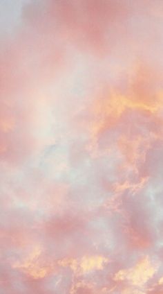 an airplane is flying high in the sky with pink and blue clouds behind it at sunset