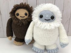 two crocheted stuffed animals sitting next to each other