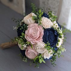 a bridal bouquet with blue, pink and white flowers