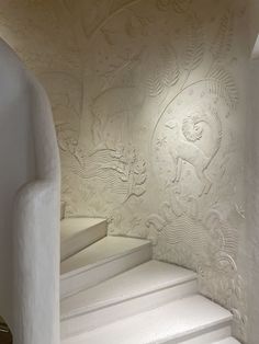 an artisticly designed room with white walls and stairs