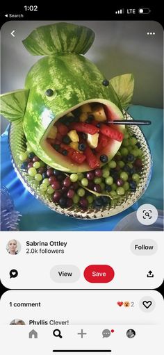 an image of a fish made out of watermelon and grapes