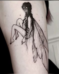 a woman's thigh with a fairy tattoo on it