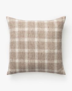 a brown plaid pillow on a white background