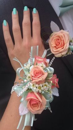 the bride's bouquet is adorned with peach roses