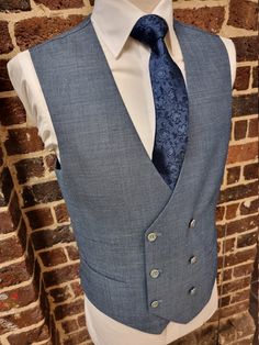 "New men`s Wool & linen Double Breasted Waistcoat in a soft blue woven fabric. This light weight and very versatile waistcoat looks great with jeans but also with the matching jacket as shown.  The DB Waistcoat has 6 buttons and 2 pockets (stitched but can be opened) and a blue matching back in the same fabric with an adjuster. There is also a matching jacket & trousers available to make it into a 3 pce. suit ideal for a wedding or a day at the races. Chest sizes from 36\" to 50\"" Formal Blue Vest With Buttons, Fitted Blue Nehru Jacket For Work, Fitted Blue Nehru Jacket For Spring, Fitted Blue Nehru Jacket For Semi-formal Occasions, Blue Fitted Nehru Jacket For Semi-formal Occasions, Blue Fitted Nehru Jacket For Groom, Formal Linen Dress, Wool Waistcoat, Double Breasted Waistcoat