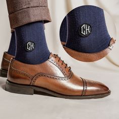 a pair of brown shoes with blue socks and monogrammed initials on the soles