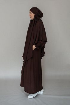 Introducing the Myyla Prayer Gown Umrah Abaya Dress, a stunning and elegant piece of modest wear that is perfect for any prayer or Hajj occasion. Made by the renowned brand Annah Hariri, this abaya dress is crafted with high-quality non-wrinkling fabric that ensures that you always look your best.The Myyla Prayer Gown features a beautiful dark coffee color and is designed as a completely covered one-piece abaya with an A-cut style that flatters your figure. The dress comes with pockets, which ar Modest Brown Maxi Dress, Brown Khimar For Eid, Brown Long Sleeve Khimar For Eid, Modest Long Brown Maxi Dress, Brown Long Thobe For Eid, Modest Brown Abaya For Eid, Umrah Abaya, Annah Hariri, Dark Coffee