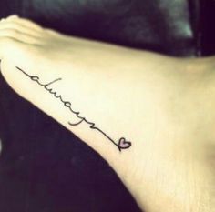 a woman's foot with the word love written in cursive writing on it