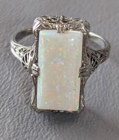 Estate Opal ring. Ring features ornate 14k White Gold setting with 8mm x 16mm Opal prong set. Ring would make a wonderful alternative engagement ring. Ring will arrive gift boxed. * HALLMARKS 14k, Designer mark. * SIZE 10, Opal measures 8mm x 16mm * CONDITION In very good condition. Please use all pictures as part of item's description. * MATERIALS 14k White Gold, Opal. White Gold Opal Ring, Alternative Engagement Ring, Opal Ring Gold, White Gold Set, Set Ring, Alternative Engagement Rings, Opal Ring, Ring Ring, Opal Rings