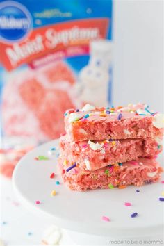 two pieces of cake sitting on top of a white plate next to a bag of marshmallows