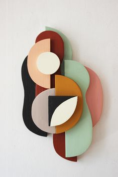 an art piece made out of wood and painted with different colors