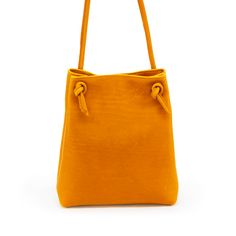 Turmeric Fun meets function with our perfect summer addition— please meet the Bikini Bag! All the best parts of a shoulder bag (the ease! the class!) but with a twist, because nothing in life should be boring. High quality full grain chrome tanned leather throughout Magnetic closure 10” wide, 12” tall, 3” deep. 8x6 interior compartmentalized pocket. Unlined Textured Leather Bucket Bag In Pouch Shape For Everyday, Textured Leather Bucket Bag Pouch For Everyday Use, Yellow Textured Leather Travel Bag, Daily Use Crossbody Bucket Bag In Textured Leather, Crossbody Textured Leather Bucket Bag For Daily Use, Leather Shoulder Bag With Removable Pouch For Summer, Textured Leather Crossbody Bucket Bag For Daily Use, Leather Shoulder Bag For Daily Use In Summer, Chic Yellow Textured Leather Bag