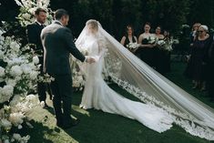 a bride and groom walking down the aisle