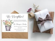 an envelope with a bow and flowers on it next to a gift bag that says, his neighbor