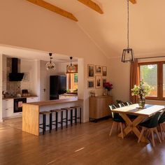 a kitchen and dining room with wood flooring