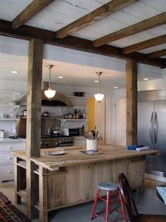 a kitchen with an island and stools in it