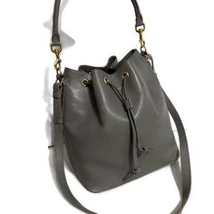 Saint Laurent Bucket Bag In A Gray Leather With Gold Hardware, Side Zippered Pocket, 5 Gold Feet, Detachable Tube Top Handle To Wear On The Shoulder With 9”Drop, Also Detachable Crossbody Strap With Drop Of 21”, Suede Lining With A Slid In Pocket With Name Tag On It And Serial Number. Bag Has Some Scratches From Wearing But Still In Great Condition. Designer Shoulder Bucket Bag For Errands, Luxury Shoulder Bucket Bag For Errands, Designer Bucket Bag With Detachable Strap For Errands, Designer Bucket Bag With Detachable Handle For Everyday, Designer Everyday Bucket Satchel Bag, Designer Bucket Shoulder Bag For Daily Use, Luxury Crossbody Hobo Bag For Errands, Designer Shoulder Bucket Bag For Daily Use, Luxury Crossbody Bucket Bag For Errands