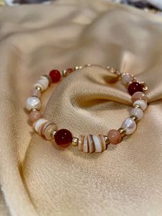 Part of the Red Sea Collection, the Red Sea Bracelet is inspired by one of the four boundaries of the Promised Land that God allotted to the Israelites, as detailed in Numbers 34:1-12. This bracelet is a beaded work consisting of carnelian, assorted agate, shells, and faux pearl beads. It has multiple chain links to clasp the bracelet together so that you can adjust the bracelet to your liking. :) Bohemian Red Beaded Bracelets With Spacer Beads, Bohemian Red Beaded Bracelet With Spacer Beads, Red Polished Beads Bracelet As Gift, Elegant Red Beaded Bracelets With Spacer Beads, Spiritual Red Beaded Bracelets, Red Polished Beads Bracelet For Gift, Red Beaded Bracelets For The Beach, Elegant Red Beaded Bracelets, Red Bohemian Beaded Bracelets