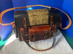 This is a large, handcrafted, leather messenger or carry-on bag.  It has two side pockets, a front pocket, and a zippered pocket in the back. Dimensions are:  30 inches long, by 8 inches wide, by 10 inches tall total.  The pockets are each 2 inches deep. Note that the gold caiman skin on the cover is an optional add-on for $20.  Please let me know in the notes after purchase if you would like this.  The cover is plain leather otherwise. Multi-colored options are available at no extra charge.  Pl Leather Satchel Shoulder Bag With Multiple Pockets, Brown Satchel Shoulder Bag With Multiple Pockets, Brown Shoulder Satchel With Multiple Pockets, Leather Tote Bag With Multiple Pockets, Leather Shoulder Bag With Multiple Pockets, Leather Crossbody Bag With Multiple Pockets, Luxury Leather Bags With Multiple Pockets, Rectangular Business Bag With Multiple Pockets, Rectangular Business Bags With Multiple Pockets