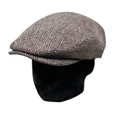 The flat cap, traditionally made of wool or tweed, has many advantages. Once worn by British and Irish farmers in the countryside, the flat cap has cycled through all social classes to become the burgeoning fashion accessory it is today. Enter the Wool Herringbone Flat Cap from Saint Martin — a flat cap that offers incredible value at a competitive price. The Herringbone Flat Cap A flat cap features soft fabric construction and a short, rounded front brim. Flat caps are constructed in two different ways, both of which feature a single-piece flat structure. Saint Martin is a reputable hat manufacturer that has been in business for decades. The brand's credibility for meticulous, high-quality construction is unparalleled. Product Description Featuring a comfortable sweatband, lined interior