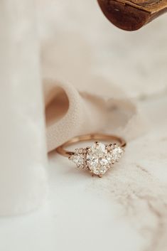 a diamond ring sitting on top of a white cloth