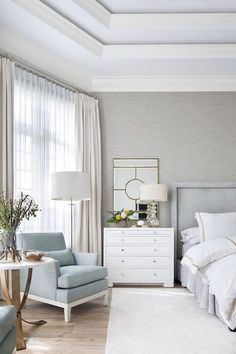 a bedroom with a bed, chair and dresser in it's centerpieces